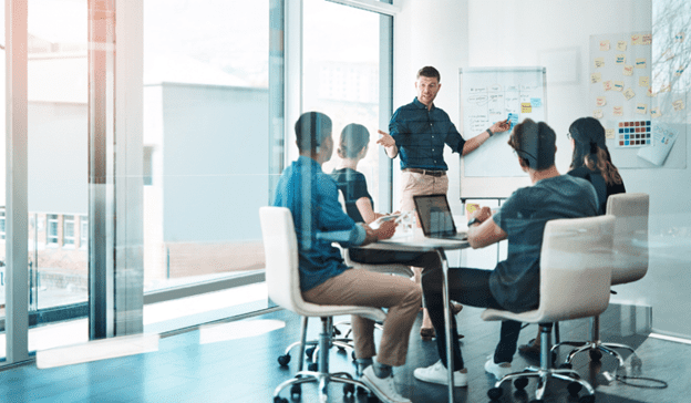 Man in meeting talking withpeers